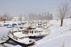 3954454-snow-covered-old-boats-in-frozen-marina.jpg