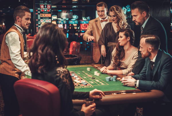 Upper class friends gambling in a casino.